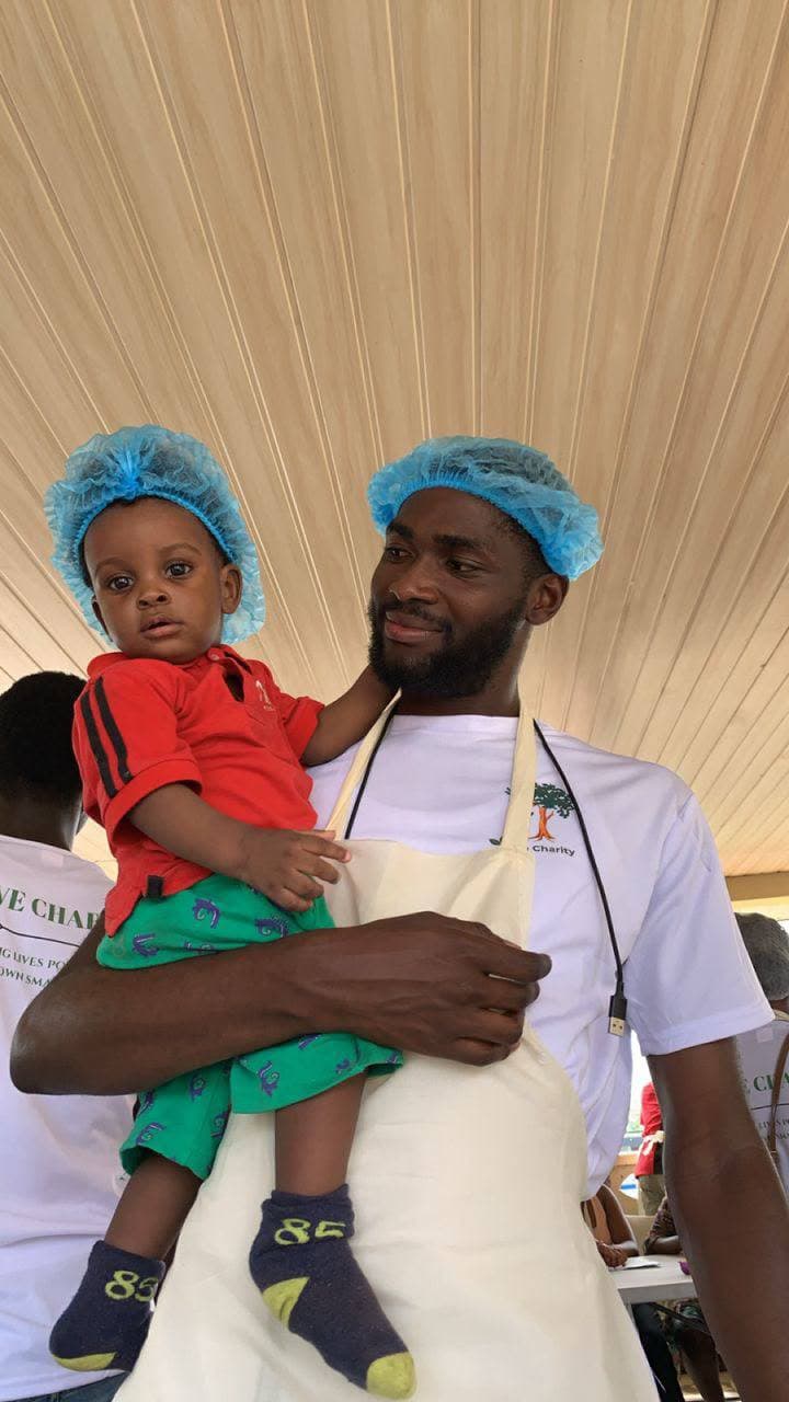 A Turning Olive Charity volunteer with a child